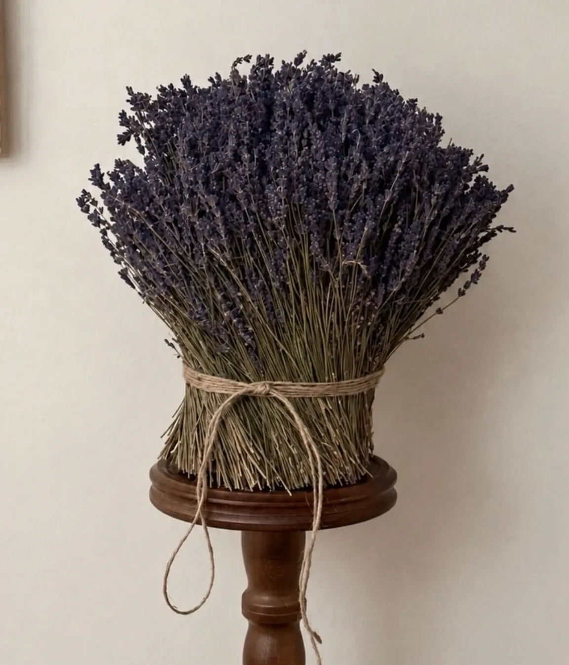 Petite Lavender Dream, a bound bouquet of dried Lavender on a wooden stand